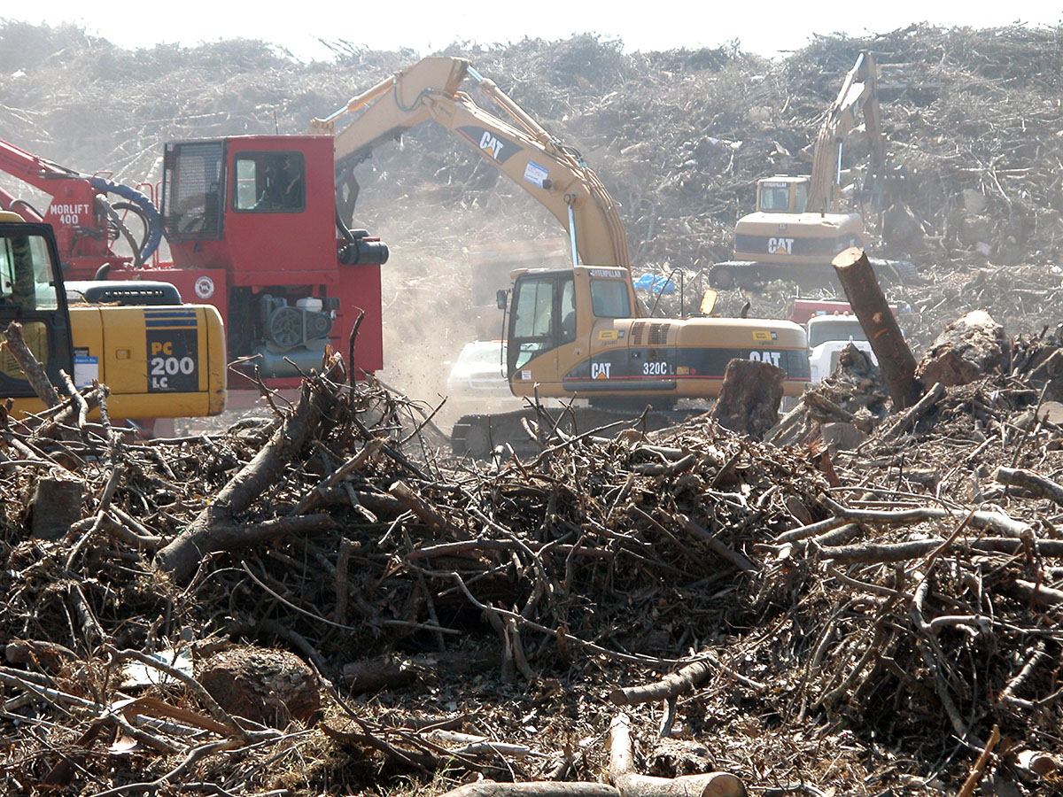 Heavy machinery at work in a massive field of debris